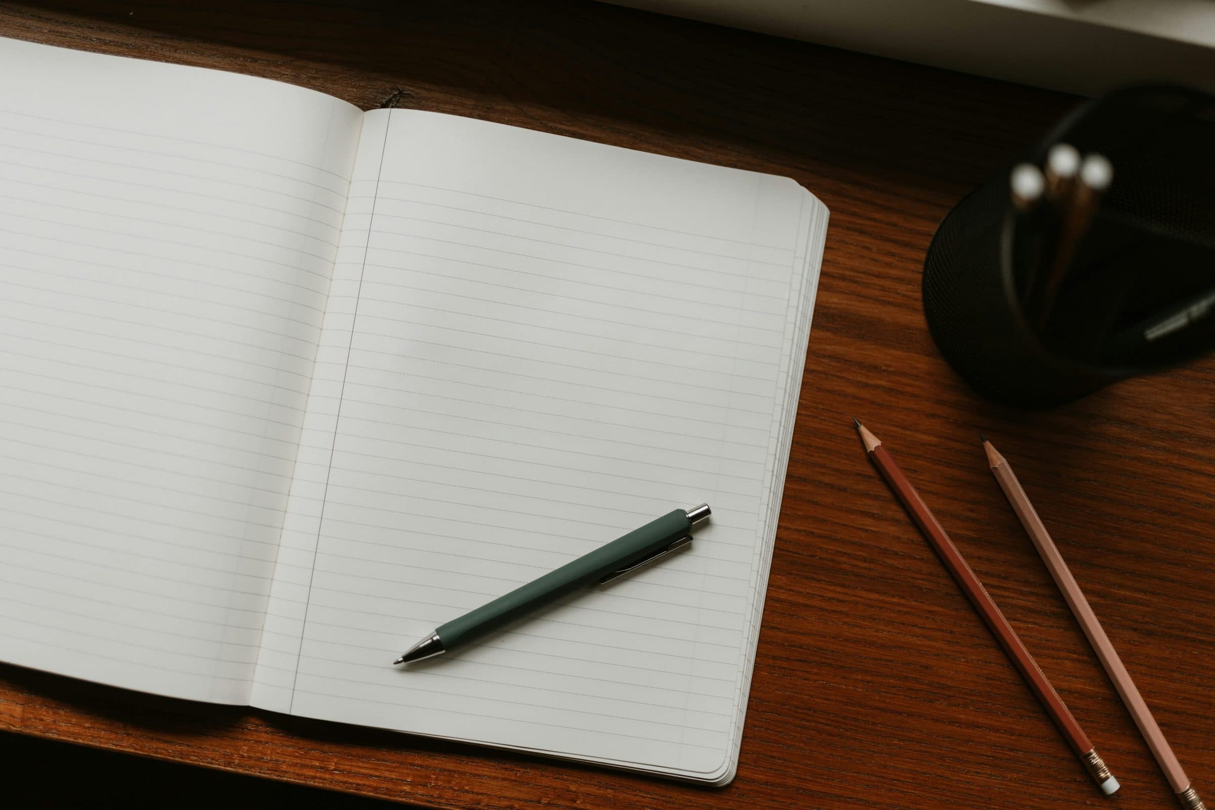 Notebooks and pens laid out before a class